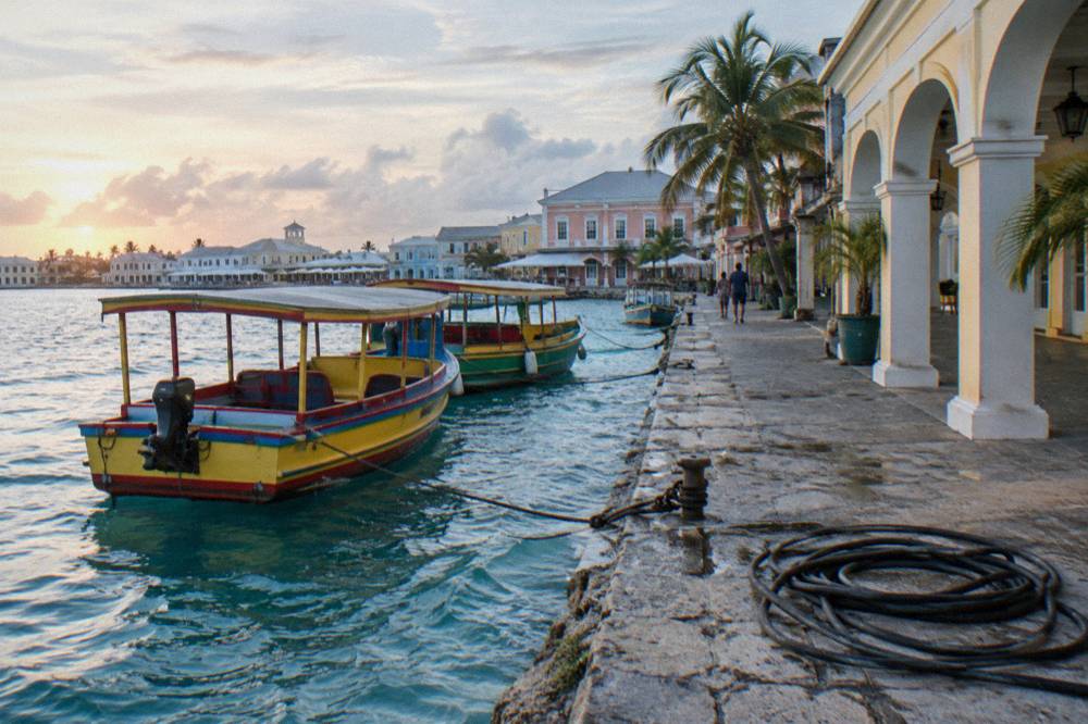 Colorful boats moored along a waterfront boardwalk near downtown Nassau