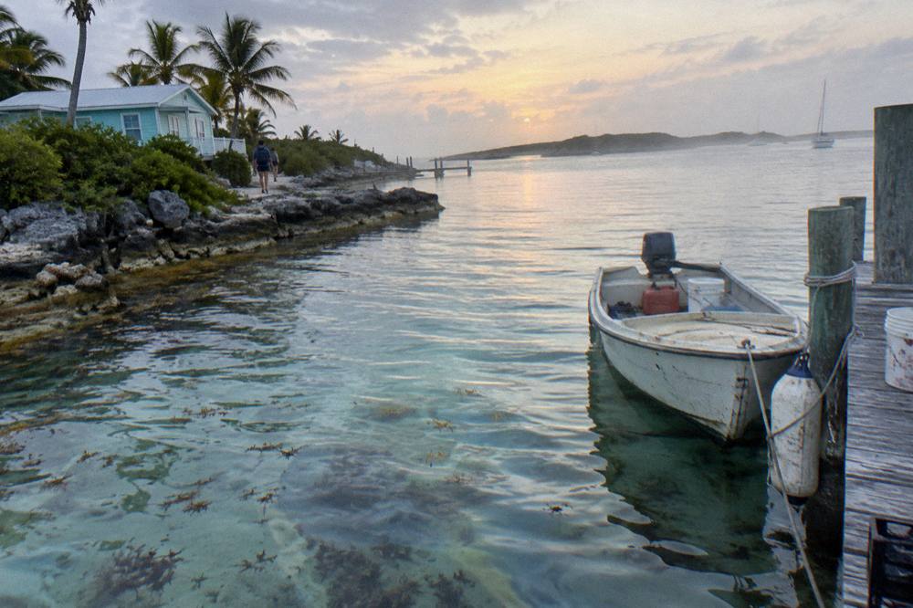 A calm morning sea with scattered small islands on the horizon