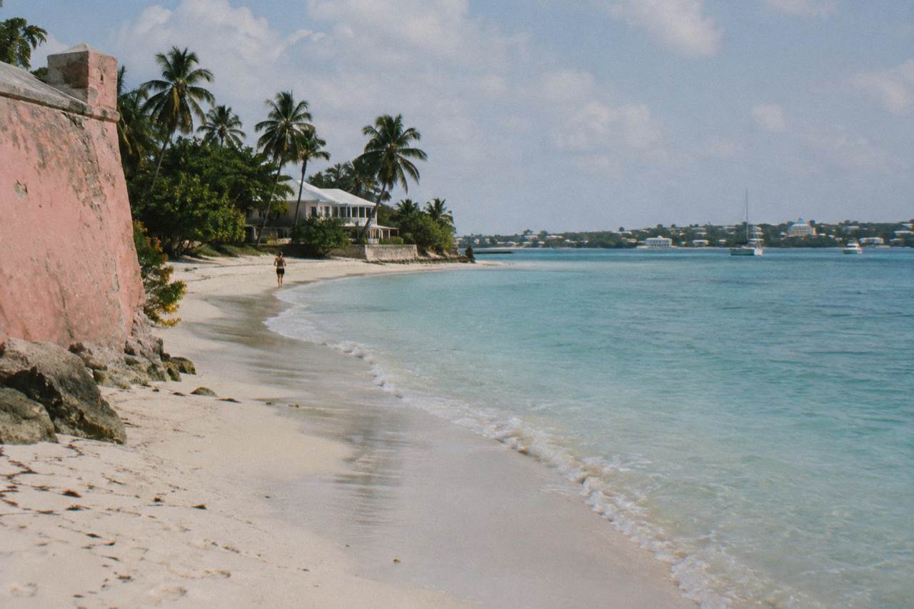 Turquoise water and a quiet public beach curve along the Nassau shoreline