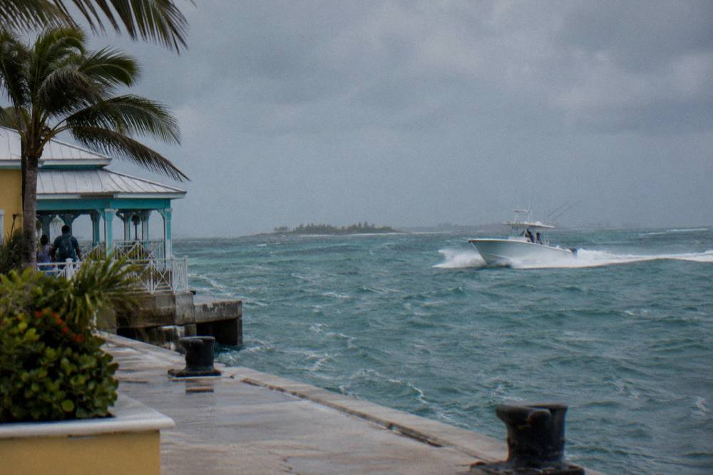 A powerboat cutting across open blue water between low islands