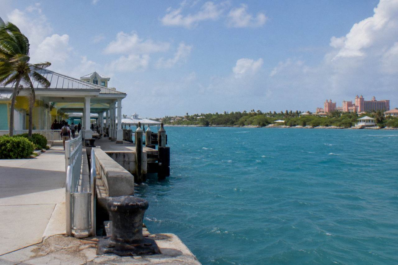 Calm turquoise water and a small island shoreline near Nassau under a bright sky