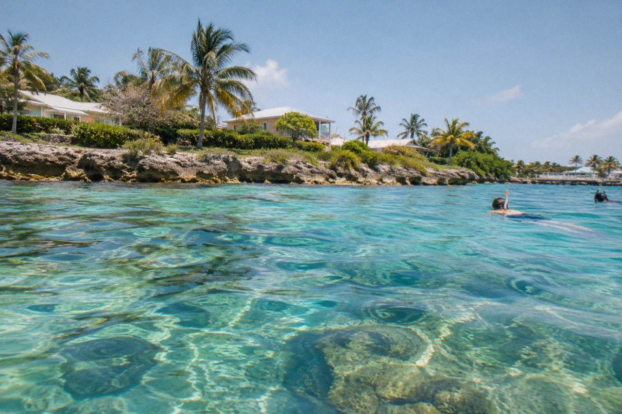 Calm turquoise water over a shallow coral reef with scattered coral heads
