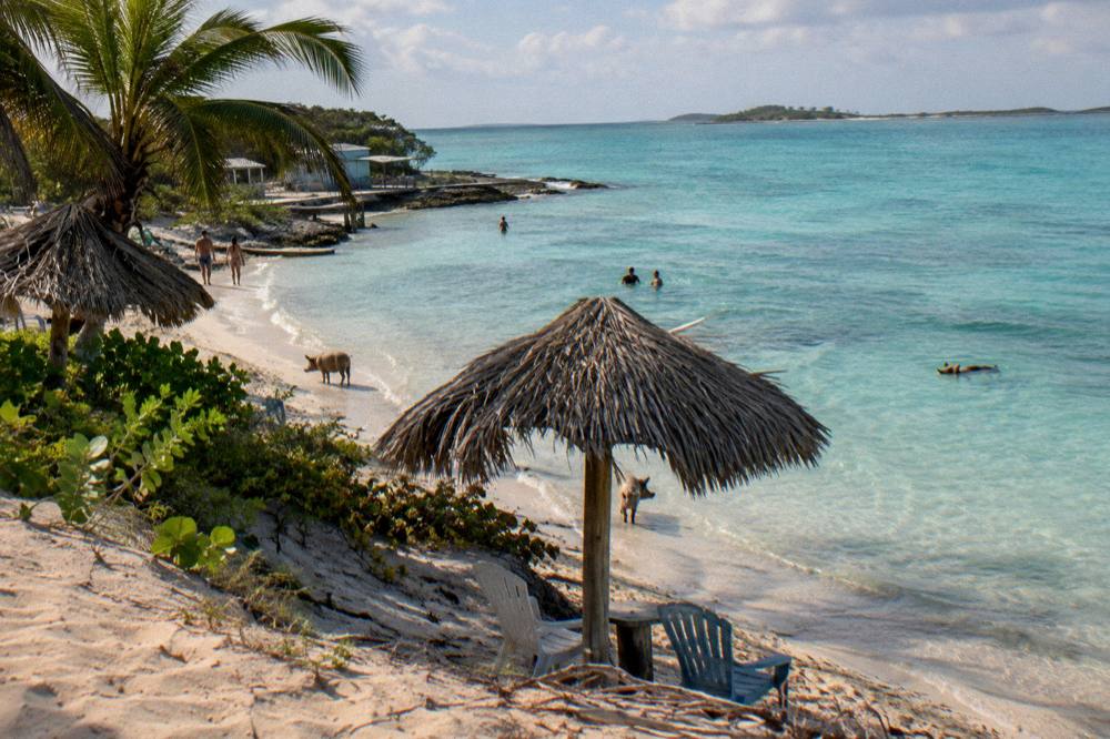Beach chairs and shaded seating on a small island beach near Nassau